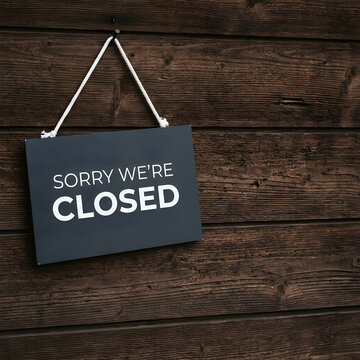 Rustic Sorry We Are Closed Sign Hanging On A Dark Wooden Wall Surface