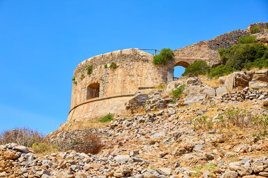 Ancient stone tower rises above rocky terrain