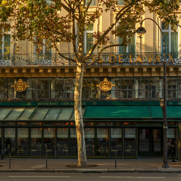 Paris, france. October 13, 2025. Paris street scene showing the iconic cafe de la paix building during autumn