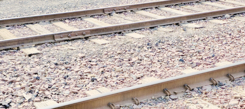 Photo of White Washed Railroad Train Tracks on rocks & gravel for Background, Backdrop, Wallpaper, Border, Frame - in tan hues