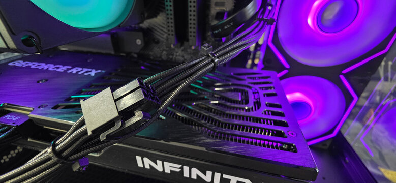 Minsk, Belarus. Jul 15, 2026. Braided GPU power cables on a GeForce RTX graphics card in an RGB gaming PC