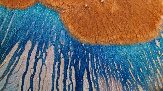 Mixing of alcohol ink creates colorful abstract patterns in macro view