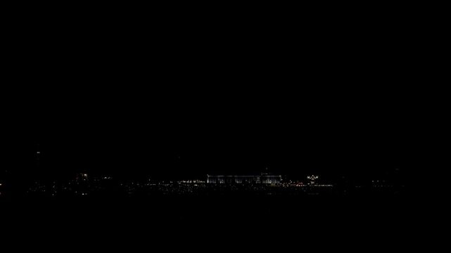 city lights hint at event, urban twilight predicts imminent gathering, nighttime cityscape reveals signs of impending assembly, city at night shows subtle signals of upcoming public gathering