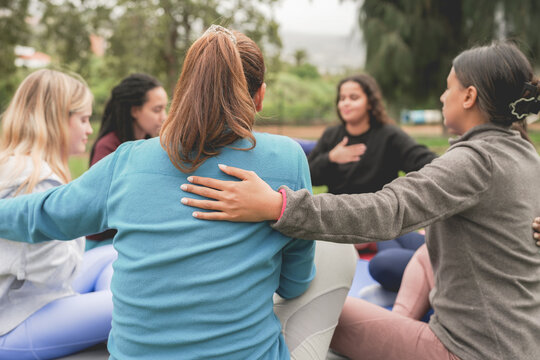 Women's circle during a group yoga class with people of different age and body types - Healthy lifestyle and meditation concept - Main focus on close up hand - UGC content