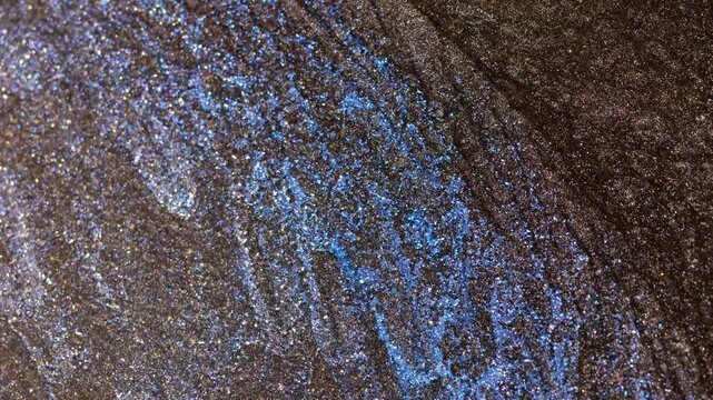 Mixing alcohol ink in a close-up view of swirling patterns