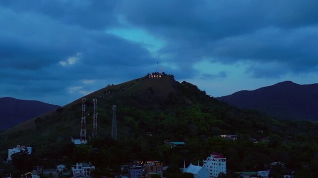 Coron town sign illuminating Mount Tapyas at dusk. Best aerial view drone