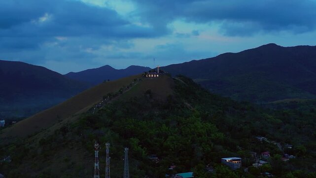 Coron town sign illuminating Mount Tapyas at dusk. Nice aerial view drone