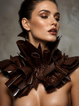 High fashion winter 2026 concept with elegant model wearing sculptural dark chocolate collar, avant garde food couture, editorial style, copy space.