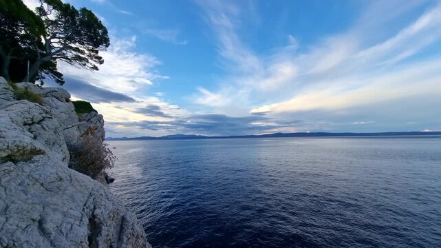 The calm water of the Adriatic Sea on beautiful Makarska riviera, Croatia, at morning, before sunrise