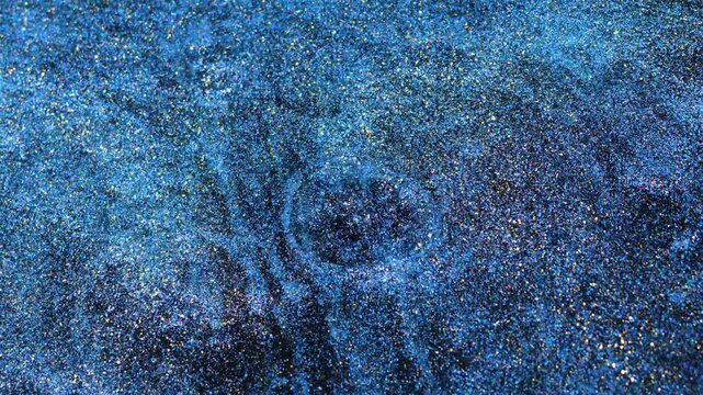Mixing alcohol ink fragments in macro view on a smooth surface