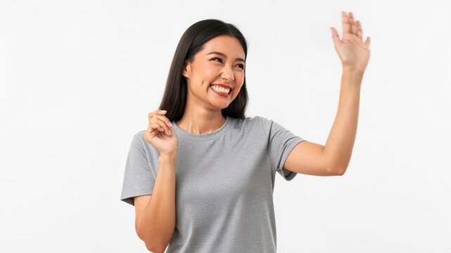 Friendly Wave: A cheerful young woman with a bright smile offers a warm wave, conveying a sense of welcome and approachability. She is dressed casually.