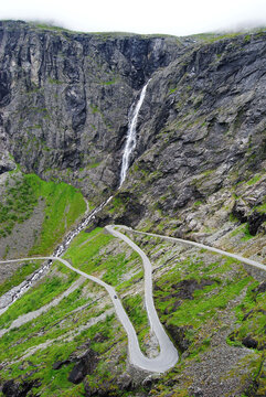 Trollstigen mountain road beneath Stigfossen waterfall in Norway