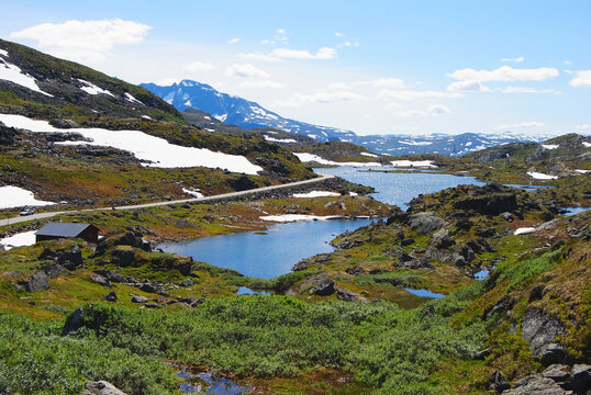 Alpine lakes and snowy mountain landscape in Sognefjellet, Norway