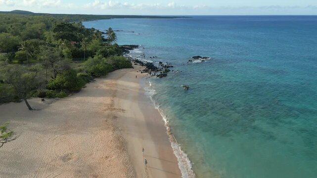 Aerial over Ahihi Bay, Makena Beach and Makena Cove in Kihei on Maui, Hawaii. April, 2023 during early morning, volcanic rock and coral visible off the coastal blue waters.