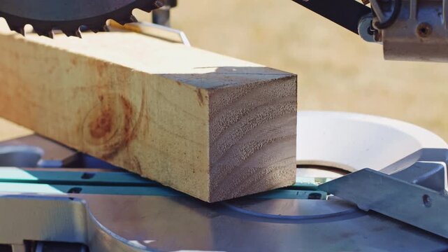 Close-up pine wood block grain texture on miter saw table