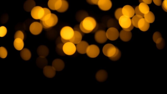 Golden yellow bokeh lights on black background
