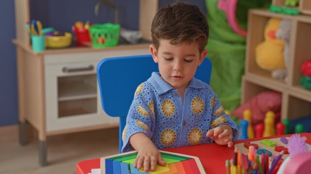 Young boy reaches for wooden rainbow toy with his hand, turning head amid shelves and colorful blocks in a playroom; curiosity focus.