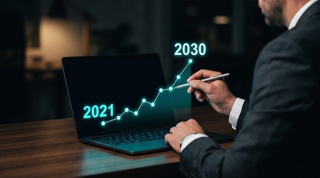 Businessman analyzing a glowing growth chart from 2021 to 2030 on a laptop screen with a stylus, representing business success and future planning