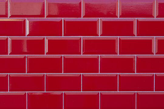 Glossy red subway tile wall background, seamless brick pattern