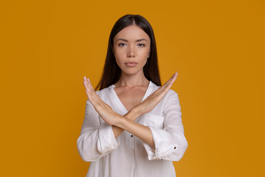 Serious woman crossing arms to say no and stop