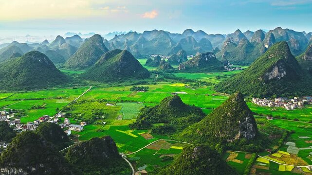 Aerial view of scenic karst landscape with green farmland and a rural village in Guilin, China