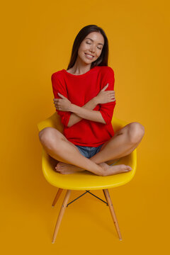 Peaceful woman hugging herself in self love and wellbeing concept