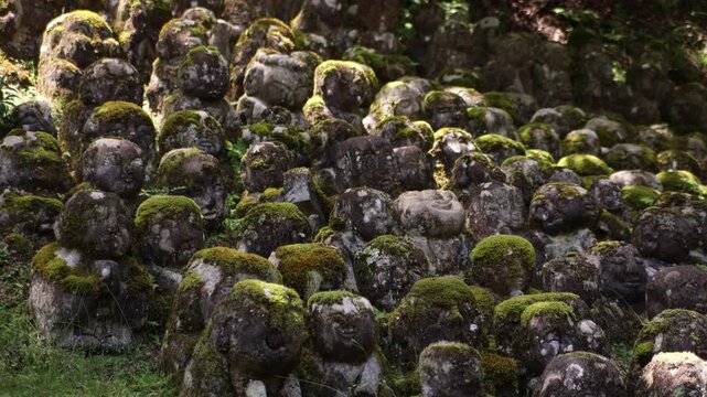 close uo panoramic view of hundreds of weathered stone Buddhist statues at Adashino Nenbutsu-ji Temple, Arashiyama district of Kyoto