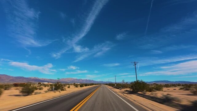 Mojave Desert POV Drive on Remote California Road Under Blue Sky