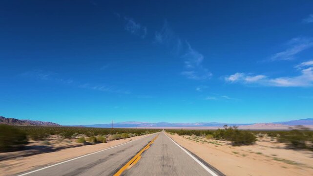Mojave Desert POV Drive on Long Straight Road Toward Mountains