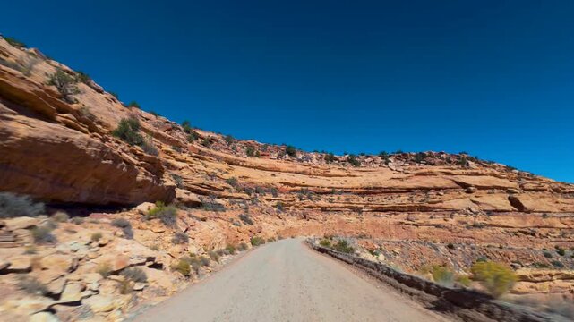 Moki Dugway POV Drive Beside Layered Sandstone Cliffs in Utah