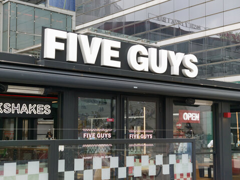 PARIS, FRANCE - SEPTEMBER 1, 2026 - Five Guys restaurant sign and storefront in La Defense business district