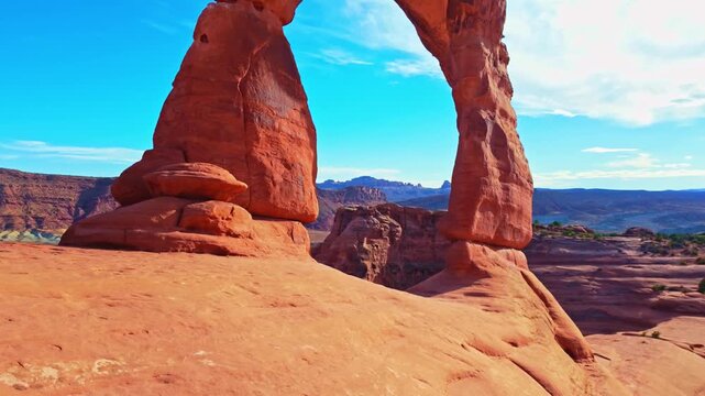 Golden sunset light glows over the iconic Delicate Arch and surrounding rim in Arches National Park