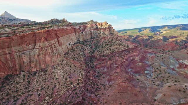 Vast red rock walls and sandstone cliffs tower over Grand Wash canyon along the Cassidy Arch trail in Capitol Reef National Park Utah
