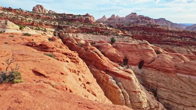 Vast red rock walls and sandstone cliffs tower over Grand Wash canyon along the Cassidy Arch trail in Capitol Reef National Park Utah