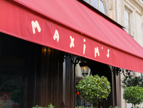 PARIS, FRANCE - SEPTEMBER 1, 2026 - Maxim's historic Art Nouveau restaurant facade with iconic red awning in Paris