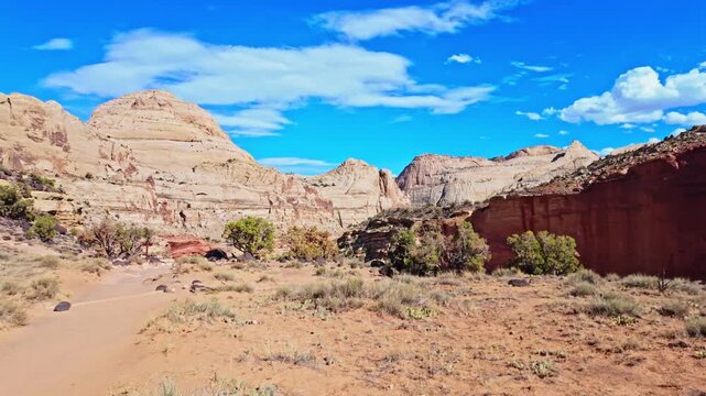 Early morning sunlight illuminates Pectols Pyramid and Navajo Dome along the Hickman Bridge trail in Capitol Reef National Park Utah