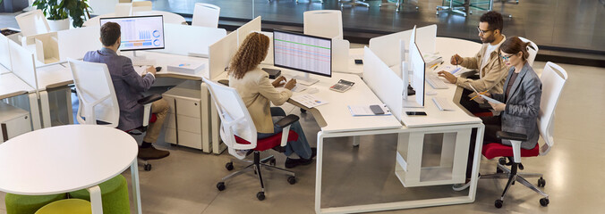 Team analysts and accountants using office computers. Businesspeople review business data charts...