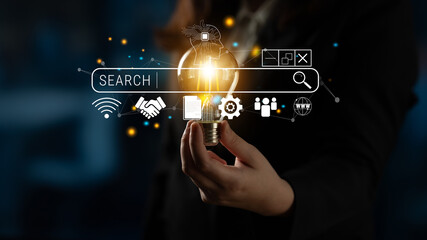 Obraz premium Innovative Concept of Light Bulb with Search Bar and Digital Icons Representing Creativity, Ideas, and Modern Technology Fusion in a Business Environment Quark.