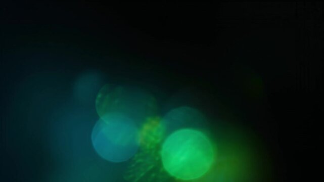 Abstract blue and green light leaks glowing against a dark background on transparent background