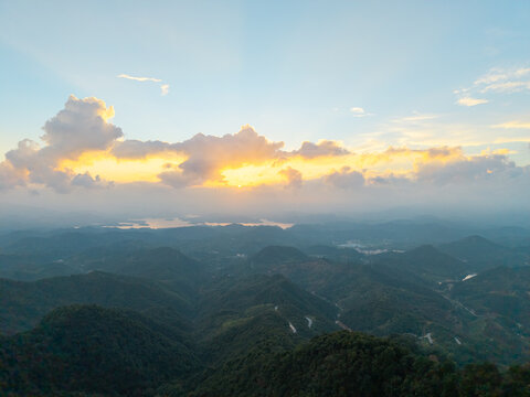 A beautiful sunset illuminates the rolling mountains of the Dabie Mountain range located in the Hubei province of China with a scenic view over the landscape
