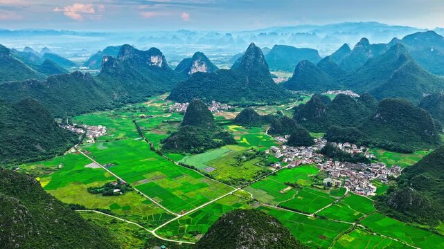 Aerial view of scenic karst landscape with green farmland and a rural village in Guilin, China