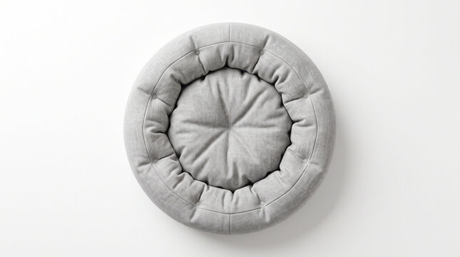 Top view of a round grey pet bed with a soft tufted cushion isolated on white background