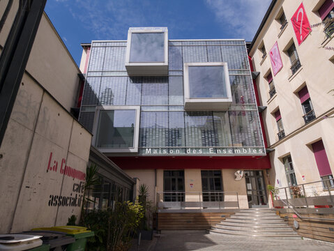 PARIS, FRANCE - SEPTEMBER 1, 2026 - Maison des Ensembles, a modern community center, featuring glass windows and red accents
