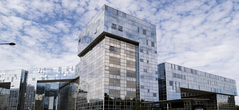 PARIS, FRANCE - SEPTEMBER 1, 2026 - Ponant Complex featuring modern glass facades and reflecting clouds in Paris, France