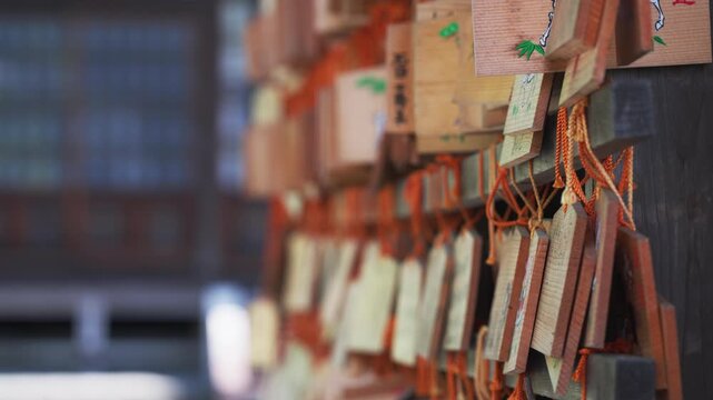 Cinematic ema votive plaques with bokeh at a Tokyo shrine in Japan