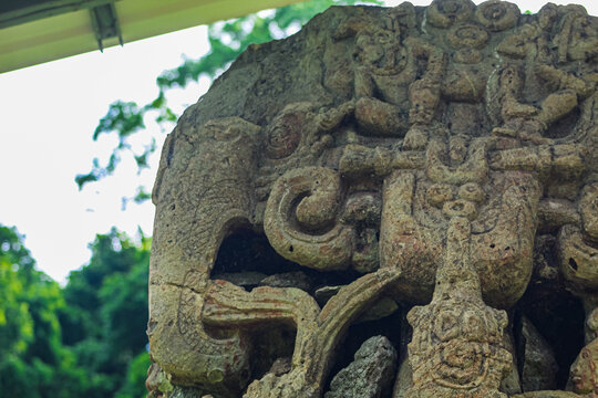 Ancient sculpted gaze and right side headdress with macaw on Maya Stela B of 18 Rabbit 