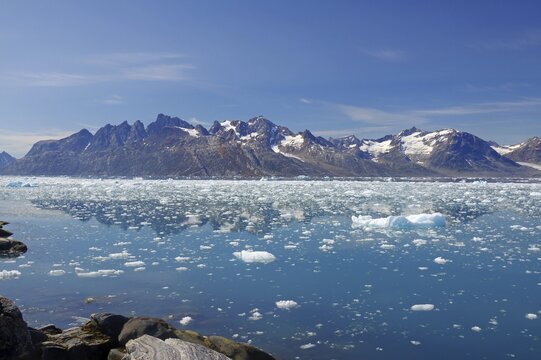 View of a fjord filled with drift ice, rugged mountains in the background, summer, Arctic, Knud Rasmussen Fjord, Tasilaq, Greenland, Denmark
