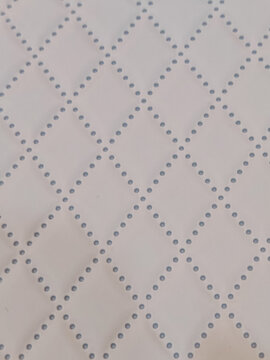 a white surface featuring a geometric diamond grid pattern made of small dots, providing a clean minimalist background for commercial design and template layouts.