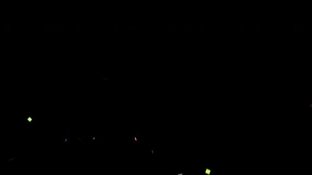 Colorful confetti falling slowly against a black background