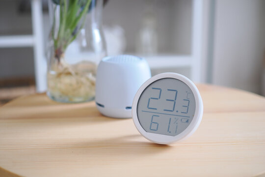 Temperature and humidity monitor on a wooden table